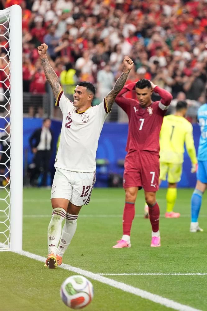 Spain's Pedro Porro (12) and Portugal's Cristiano Ronaldo (7) react after Spain defeated Portugal in the World Cup round of 16 soccer match in Arlington, Texas, near Dallas. Picture credit: AP