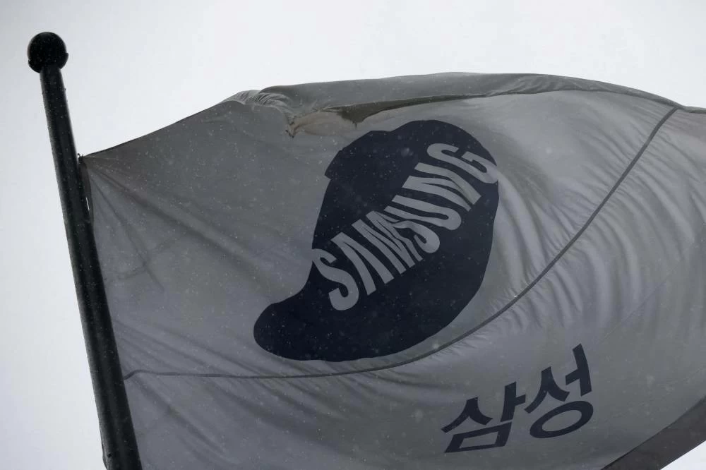 A flag bearing the logo of Samsung Electronics flutters as it rains in front of their office building in Seoul, South Korea, May 20, 2026. (Reuters)