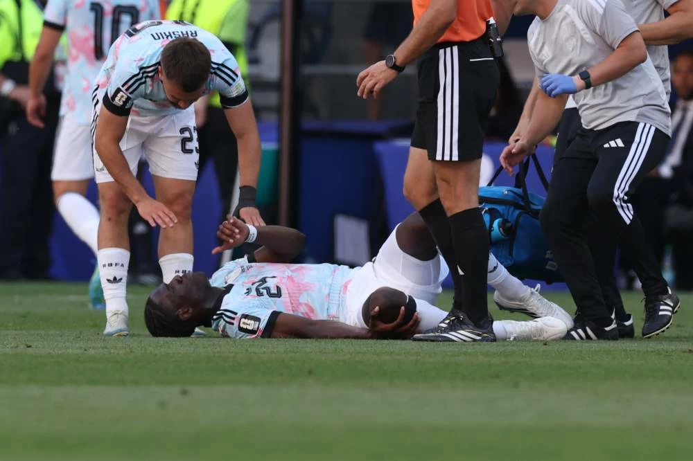 Belgium's Amadou Onana (24) lies on the field after an injury during the World Cup round of 16 soccer match between the United States and Belgium in Seattle. Picture credit: AP