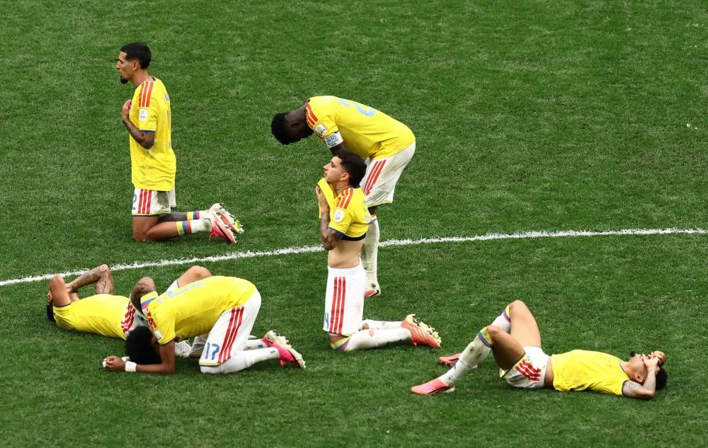 Colombia players look dejected after losing the penalty shootout as Colombia are eliminated from the World Cup. Picture credit: Reuters