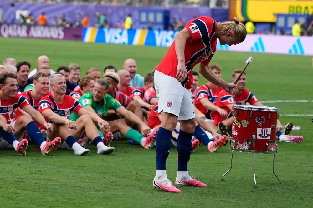 Norway's Erling Haaland (9) leads the team as they participate in a viking boat row after the World Cup round of 16 soccer match between Brazil and Norway in East Rutherford, N.J. Picture credit: AP