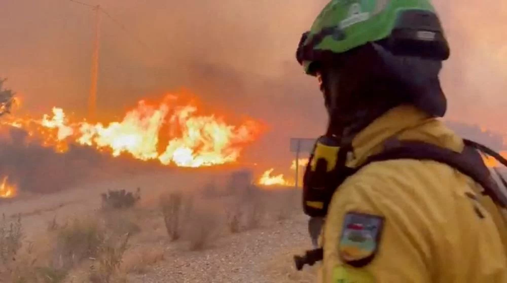 An emergency worker looks on during a wildfire in Almeria, Spain, in this screengrab taken from a handout video released on July 10, 2026.