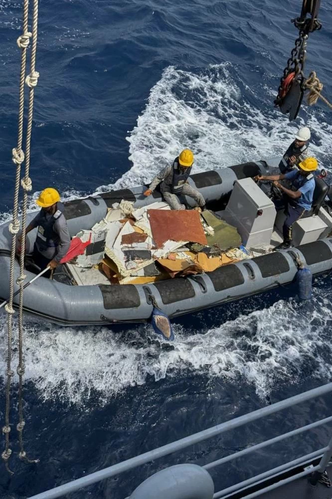 In this photo released by Pakistan Navy, Pakistan Navy personnel prepare to shift the wreckage of a cargo plane of the private carrier K2 Airways into a naval ship