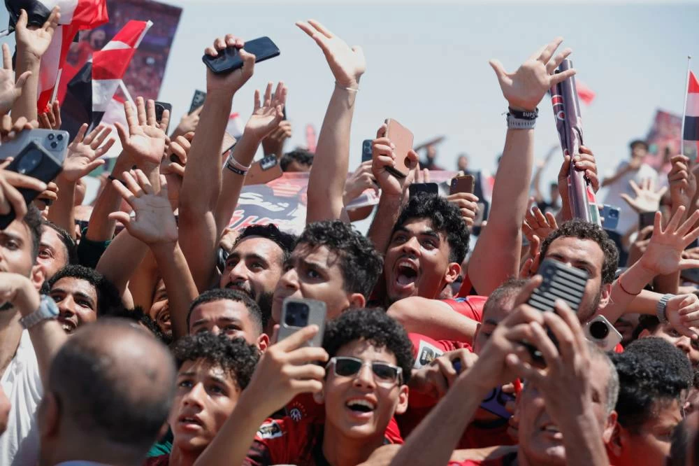 Fans crowd to greet the Egyptian national soccer team during their arrival at El-Alamein airport. Picture credit: AP