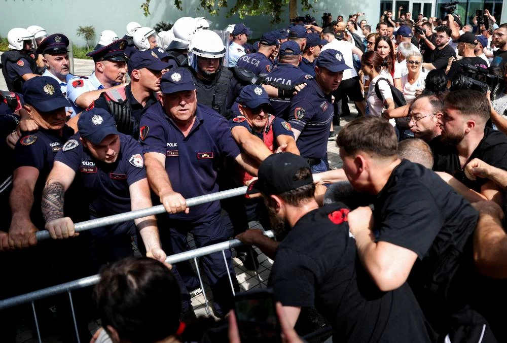 Police officers scuffle with protesters, during a demonstration, following weeks of protests against a planned luxury resort backed by a company linked to Jared Kushner, the son-in-law of U.S. President Donald Trump, on an environmentally sensitive part of the Adriatic coast, in Tirana, Albania, July 2, 2026. REUTERS