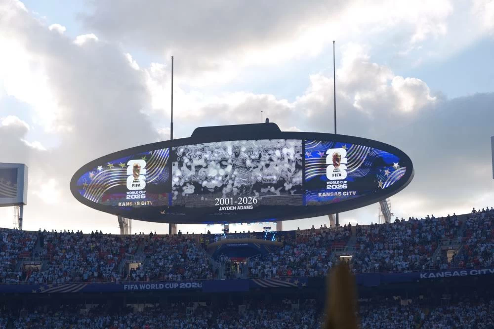 A moment of silence is held in memory of South Africa player Jayden Adams prior to the World Cup quarterfinal soccer match between Argentina and Switzerland in Kansas City, Mo., Saturday, July 11, 2026. Police said the body of the South African international was found on Saturday in the Schotsche Kloof area of Cape Town. AP