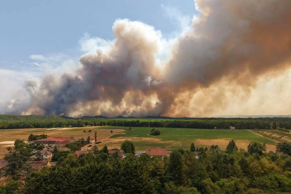 A drone view from Milly-la-Foret shows smoke rising from a wildfire the Fontainebleau forest near Paris during a heatwave affecting large parts of France, July 13, 2026. Reuters