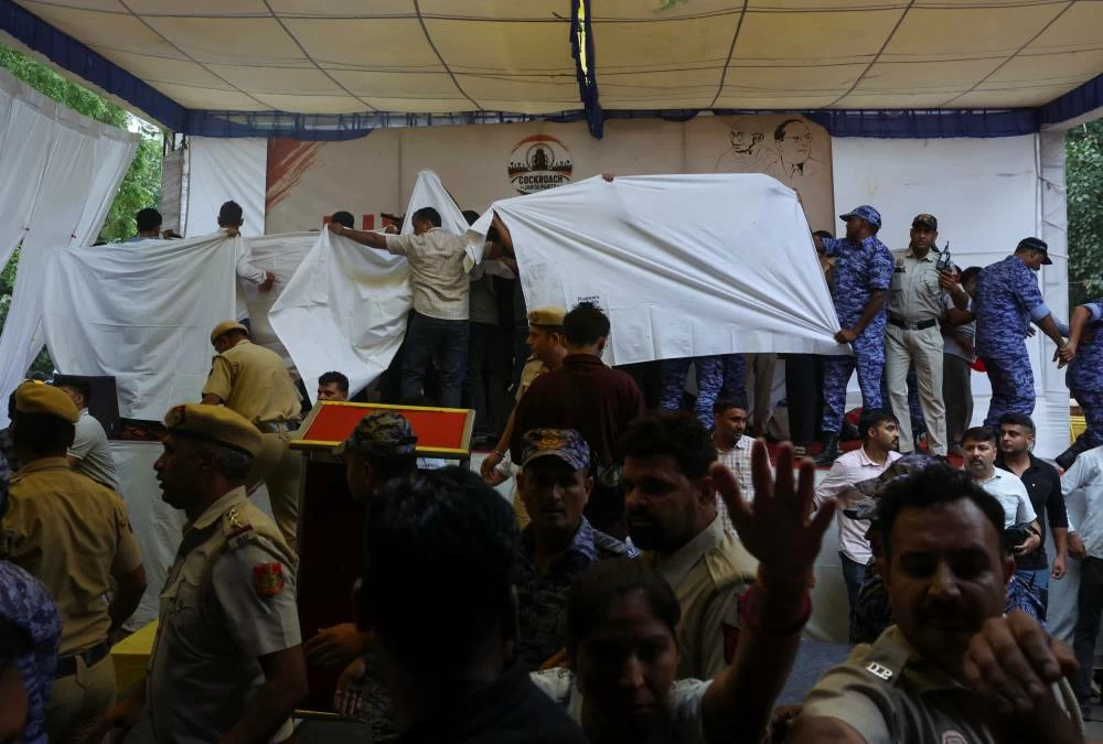 Authorities cover the stage with plain cloths as they prepare to take Sonam Wangchuk, an Indian education reformer, who has been on hunger strike, to the hospital during a sit-in protest called by Cockroach Janta Party (CJP) demanding the resignation of Indian Education Minister Dharmendra Pradhan, at Jantar Mantar in New Delhi, India, July 18, 2026. (Reuters)