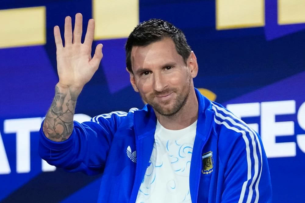 Argentina's Lionel Messi waves during a news conference ahead of the World Cup final soccer match between Spain and Argentina in New York. AP