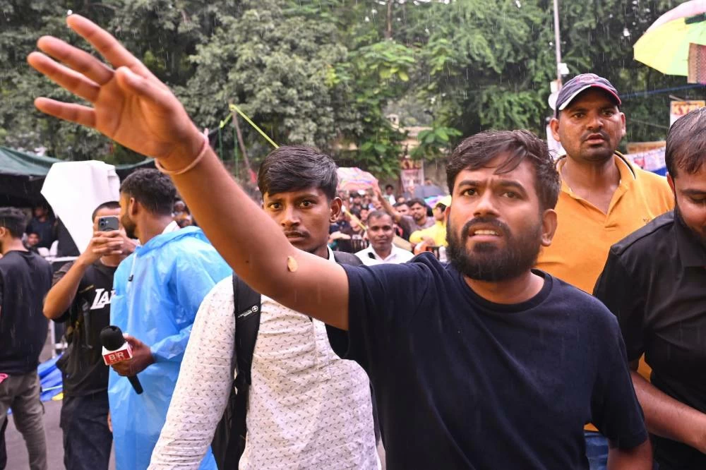 Abhijeet Dipke, founder of the Cockroach Janta Party, interacts with the protesters during a demonstration demanding educational reforms as part of the party's ongoing protest movement in New Delhi, India, Friday, July 24, 2026. (AP)