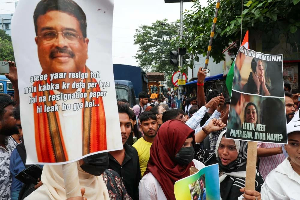 People gather in solidarity with Cockroach Janta Party (CJP) protests held at Jantar Mantar in New Delhi, with a poster of India's Education Minister Dharmendra Pradhan, in Kolkata, India, July 24, 2026. 