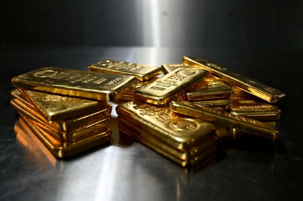 Gold slips as firm dollar weighs; focus turns to Fed meeting