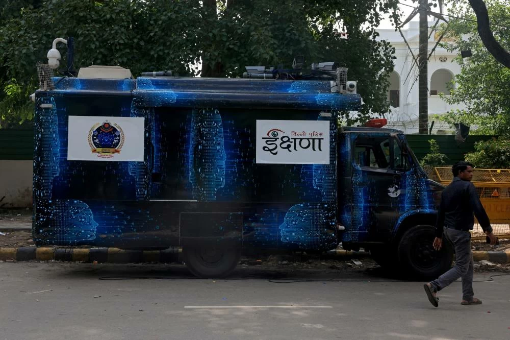 A man walks past Ikshana, a mobile surveillance van, parked at the CJP protest site. (Reuters)