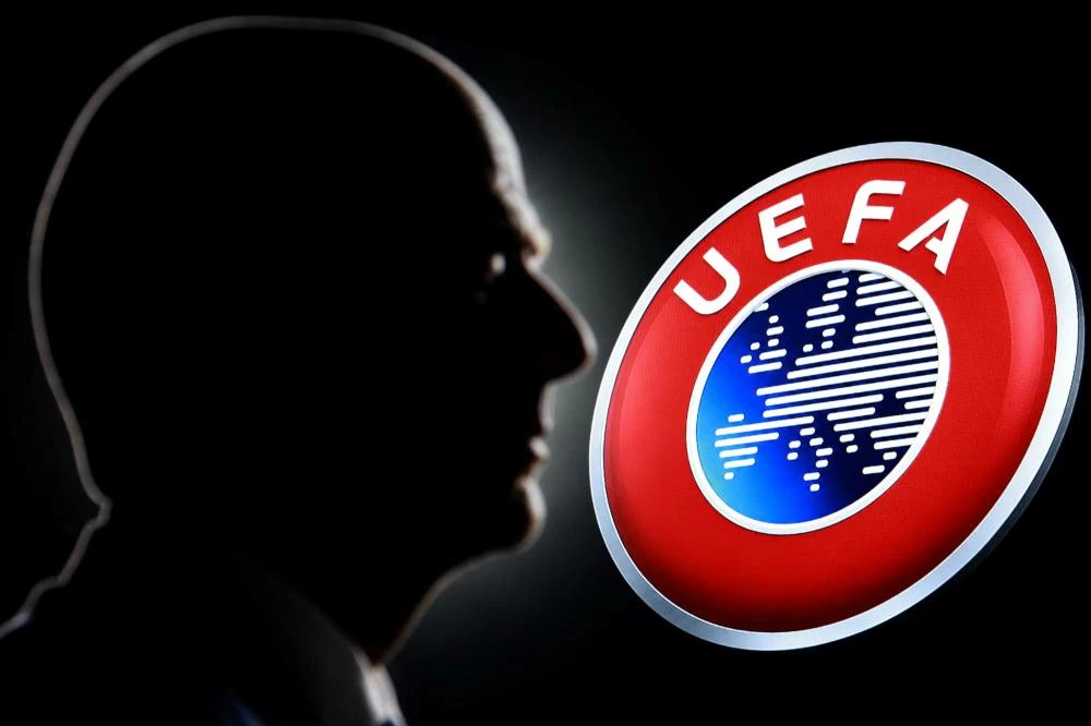 A silhouette depicting FIFA President Gianni Infantino is seen next to the UEFA logo in this illustration taken July 30, 2026. Picture credit: Reuters