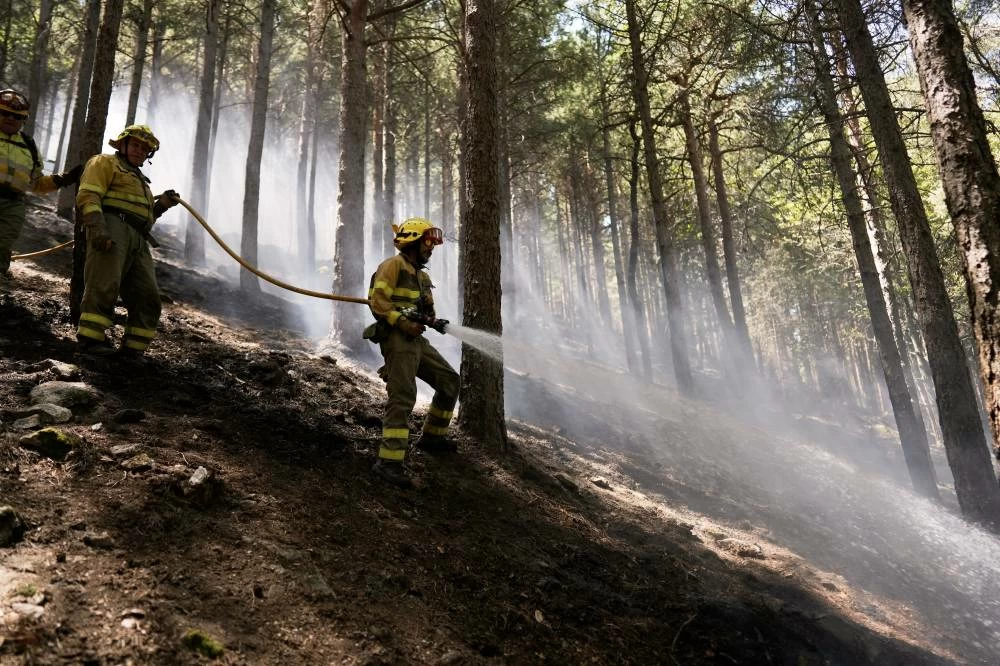 Forest rangers work in a wildfire-scorched area near Casillas, Ávila province, Spain, Wednesday, July 29, 2026. Picture credit: AP