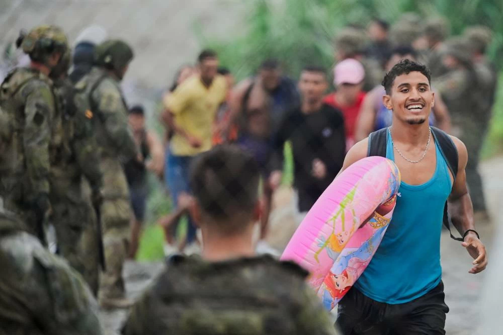 A migrant from Morocco reacts as he arrives at the Spanish border, in Ceuta, Spain, July 31, 2026, as migrants cross into Ceuta by sea and land. (Reuters)
