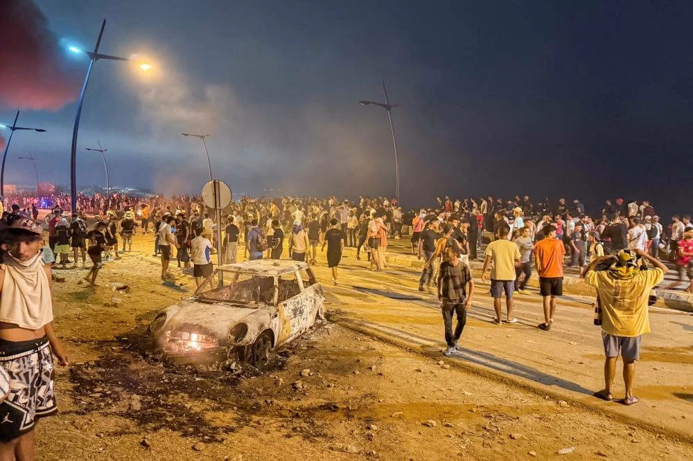 Migrants gather as they wait for a chance to cross to the Spanish enclave of Ceuta, on the Moroccan side of the border in Fnideq, Morocco, July 31, 2026. (Reuters)