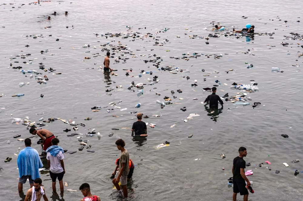 Belongings left behind by migrants float in the sea after they crossed from Morocco into the Spanish enclave of Ceuta, Friday, July 31, 2026. (AP)