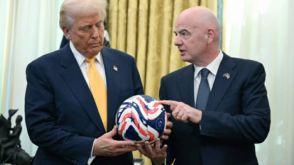 FIFA President Gianni Infantino, right, presents President Donald Trump with the new FIFA Club World Cup official ball in the Oval Office of the White House in Washington, March 7, 2025. (AP)