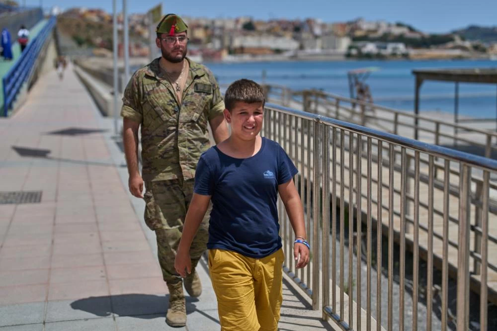 A 12-year-old unaccompanied minor who crossed into Spain cries while being escorted by a Spanish soldier to the Spain-Morocco border from the Spanish enclave of Ceuta, Monday, Aug. 3, 2026. The forced deportation of the unaccompanied minor was stopped by a high-ranking official a few meters before the child reached the border after residents and journalists said the migrant was a minor. (AP)