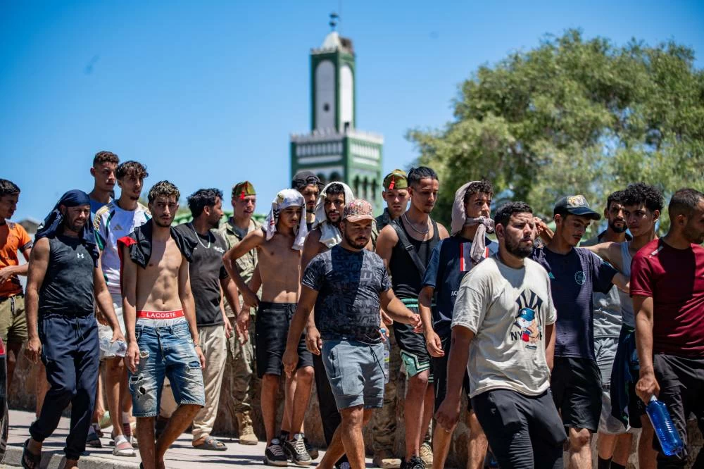 Migrants who crossed into Spain are escorted by Spanish soldiers, not pictured, toward the Spanish-Moroccan border for their return to Morocco from the Spanish enclave of Ceuta, Sunday, Aug. 2, 2026. (AP)