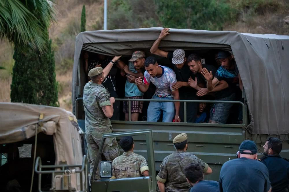 Migrants who crossed into Spain are taken towards the Spanish-Moroccan border for their return to Morocco from the Spanish enclave of Ceuta, Sunday, Aug. 2, 2026. (AP