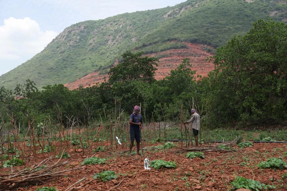 Farmers work in a field near the construction site of the Google-Adani data centre project in Tarluvada, in Visakhapatnam, Andhra Pradesh, India, August 3, 2026. (Reuters)