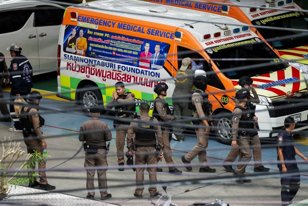 Thai police officers inside the compound of Debsirin Nonthaburi School on the outskirts of Bangkok.