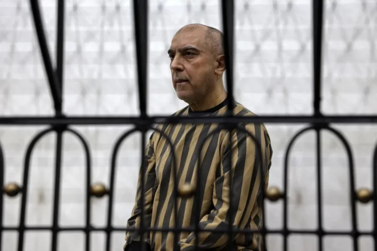 Atef Najib appeared in court under tight security and stood inside a cage wearing a prison uniform as the judge delivered the verdict.