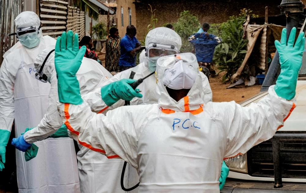File picture: Members of the Civil Protection team, which works to help mitigate the spread of the Ebola virus, wearing personal protective equipment (PPE), disinfect after handling the body of an unidentified man, who according to his family, died of Ebola, in Bunia, Ituri province, Democratic Republic of Congo, July 10, 2026. Reuters