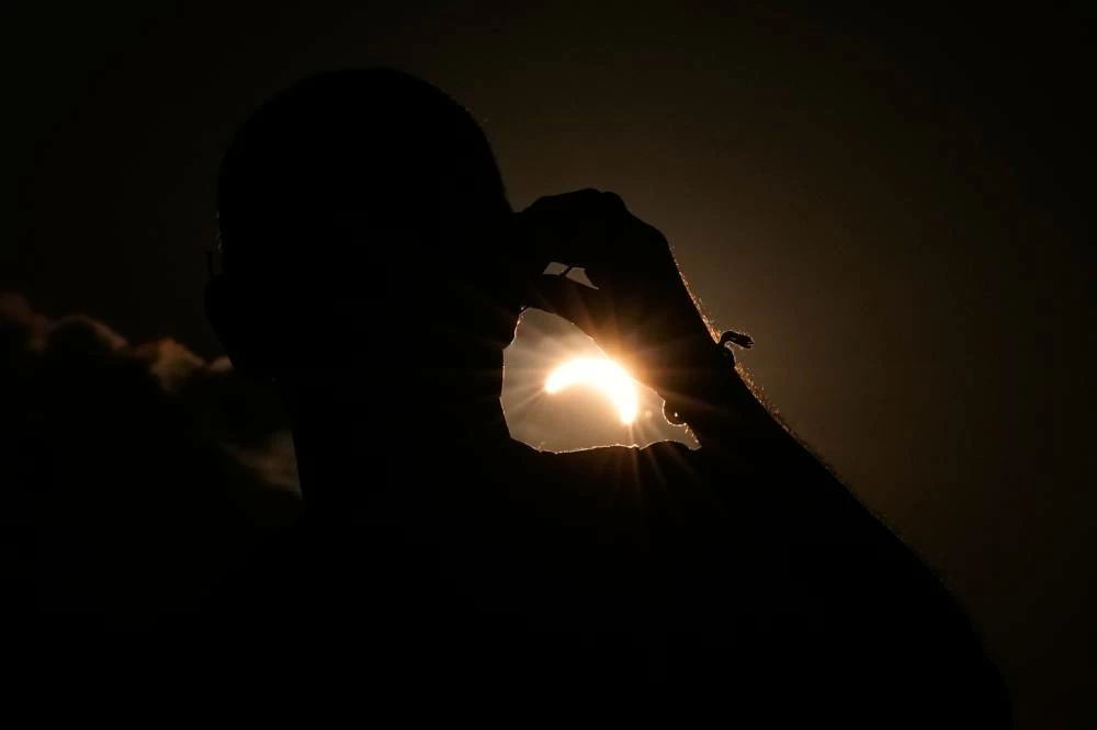 A man watches the solar eclipse at the European Athletics Championships in Birmingham, England, Wednesday, Aug. 12, 2026. Picture credit: AP
