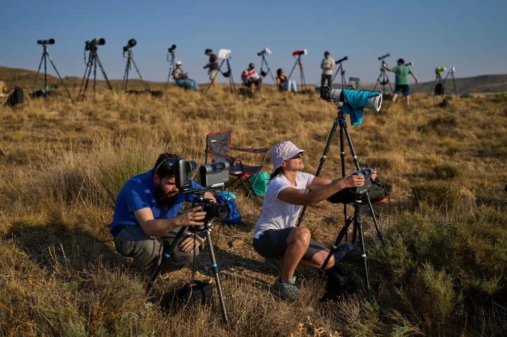 Members of the "Los Taraos" amateur astrophotography group, set up cameras to shoot a total solar eclipse in Berlanga de Duero, central Spain, Wednesday, Aug. 12, 2026. Picture credit: AP