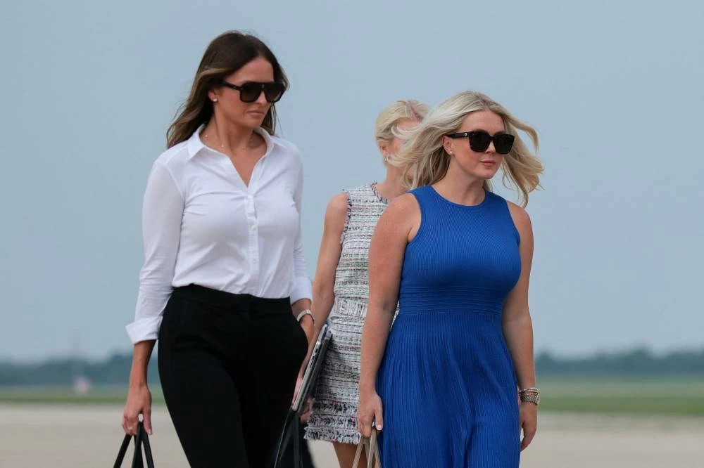 White House Press Secretary Karoline Leavitt, right, walks toward Air Force One, en route to Geneva, Ohio, at Joint Base Andrews, Maryland, U.S., August 11, 2026. (Reuters)