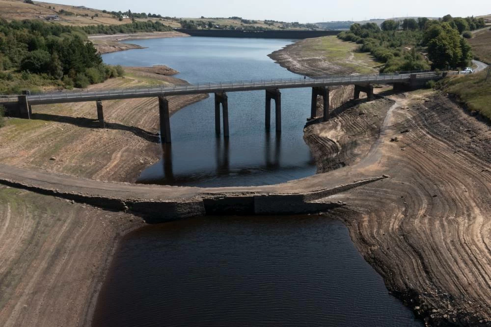 With more than two-thirds of the UK under drought conditions the historic packhorse bridge at Baitings Reservoir near Sowerby Bridge is exposed as water levels drop throught the country, in Sowerby Bridge, England, Thursday. Picture credit: AP
