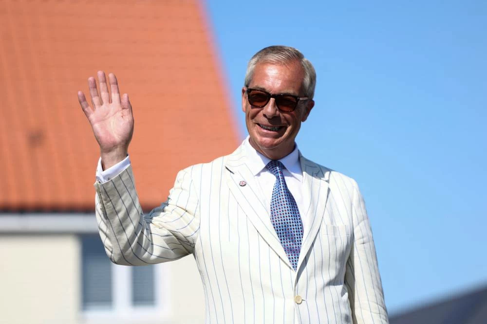 Britain's Reform UK party leader Nigel Farage arrives at his polling station for the Clacton by-election, triggered by his own resignation, in Walton-on-the-Naze, Essex, Britain, August 13, 2026. (Reuters)
