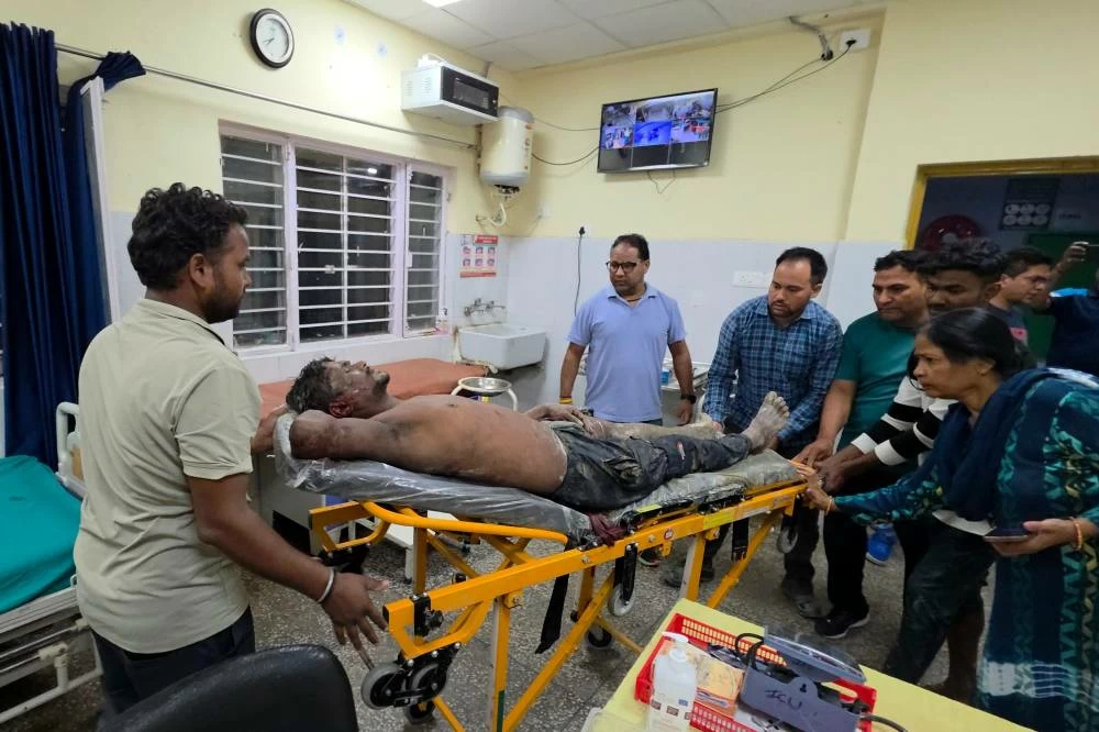An injured person is moved for treatment at a hospital after the collapse of an under-construction tunnel at a hydropower project in Chamoli district of Uttarakhand, India. (AP)