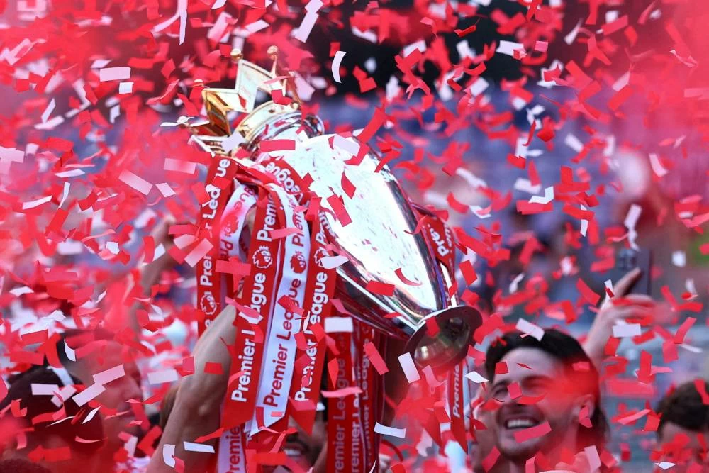 Arsenal's Martin Odegaard lifts the trophy as he celebrates with teammates after winning the Premier League. Picture credit: Reuters