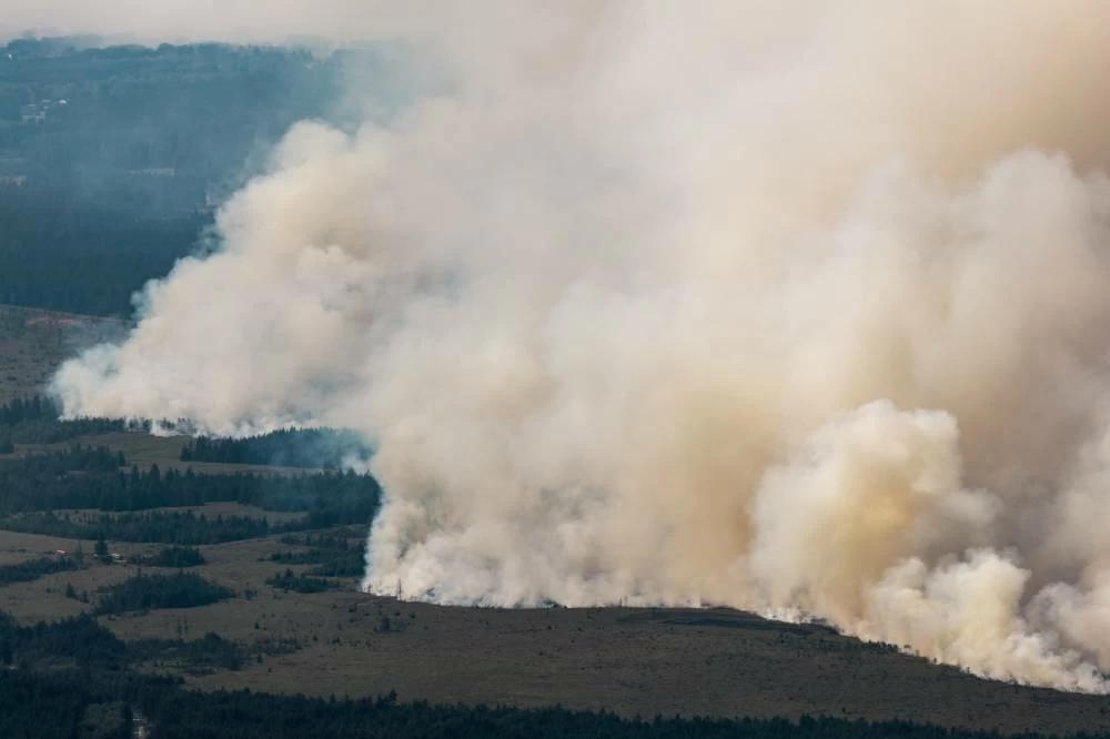 Smoke from a massive wildfire in Belgium's Hohes Venn region is seen from Germany, Sunday, Aug. 16, 2026. AP