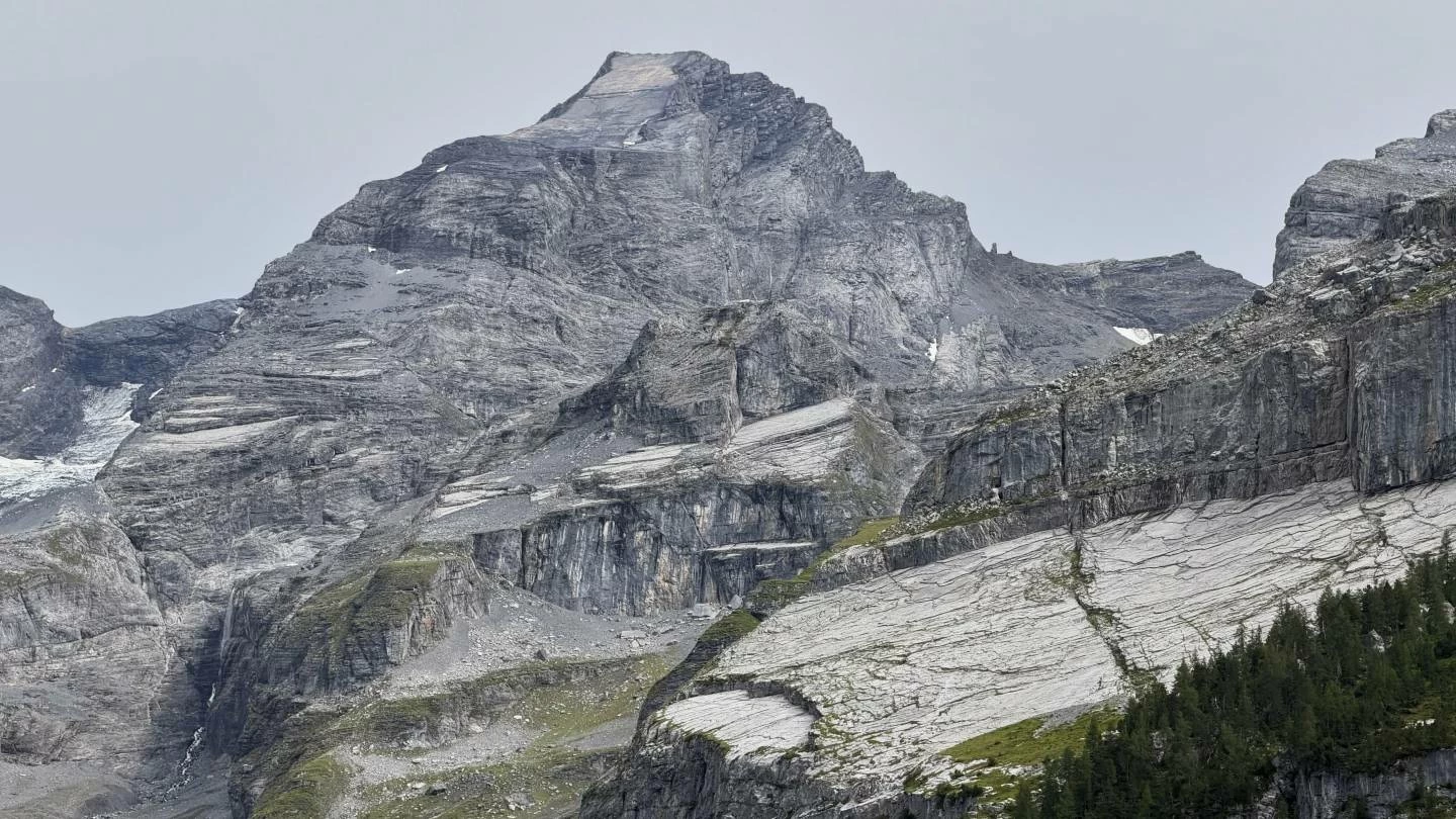 A view of the ‘Spitze Stei’ rock, with the Bluemlisalphorn peak in the background, seen over the Oeschinensee near Kandersteg, Switzerland. (AP)