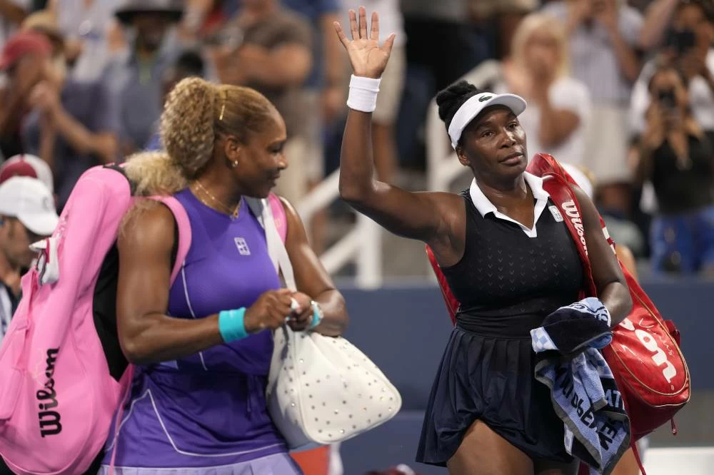 Serena Williams, left, and Venus Williams, right, both of the United States, wave to the crowd at the end of a women's doubles match against Marta Kostyuk, of Ukraine, and Peyton Stearns, also of the United States, at the Cincinnati Open tennis tournament, Monday, Aug. 17, 2026, in Mason, Ohio. Picture credit: AP