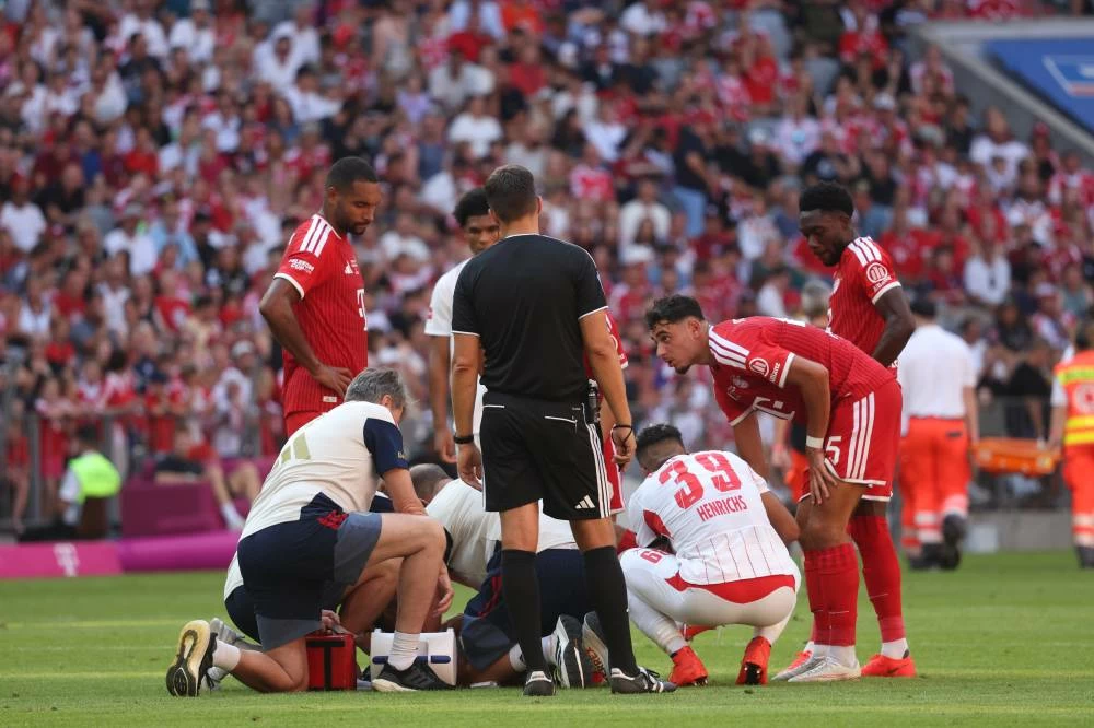 Munich's Jamal Musiala receives medical treatment during a pre-season soccer match between FC Bayern Munich and RB Leipzig in Munich, Germany, Saturday, Aug. 15, 2026.  (AP)