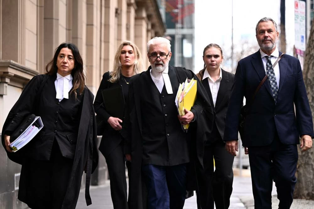 Erin Patterson's barristers Veronika Drago and Richard Edney, and solicitor Bill Doogue, return to court during a break at the Supreme Court in Melbourne, Australia, August 19, 202. (Reuters)