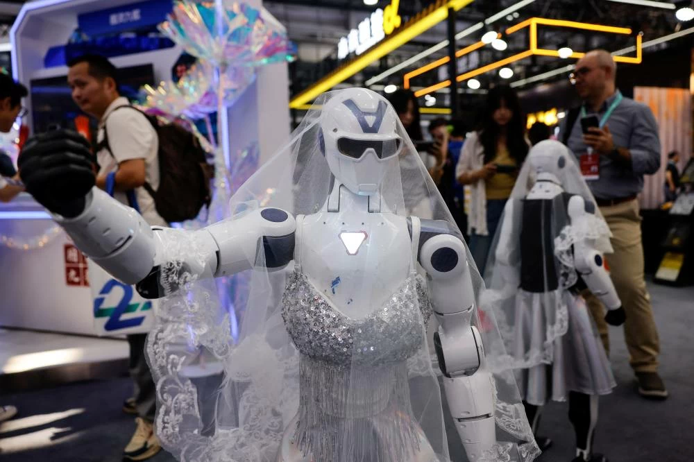 People gather next to humanoid robots wearing wedding dresses at the 2026 World Robot Conference, in Beijing, China, August 19, 2026. (Reuters)
