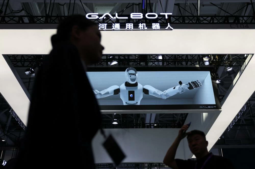 Visitors walk past a Galbot booth during the 2026 World Robot Conference, in Beijing, China August 19, 2026. (Reuters)