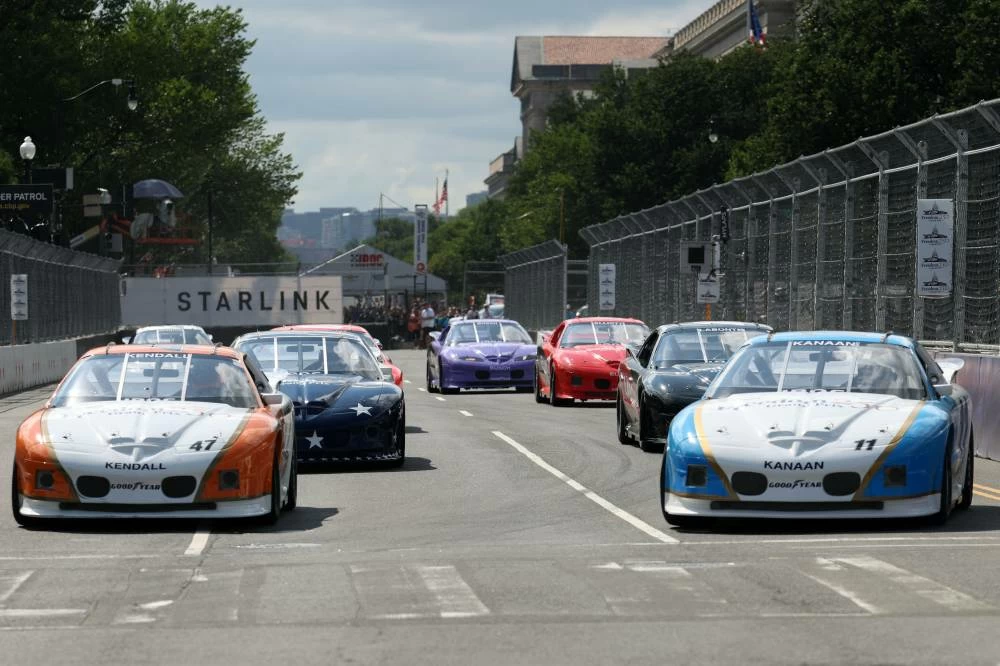 Toy Kanaan (11) and Tommy Kendall (47) lead a pack of cars during the IROC event as part of the Freedom 250 Grand Prix on the street circuit of National Mall. Reuters