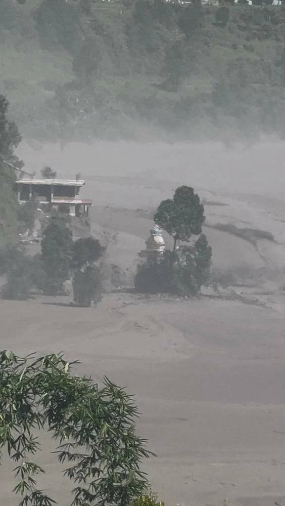 Partially submerged buildings along the riverbank due to a flash flood in Nuwakot district, Nepal, August 26, 2026, in this screen grab obtained from a handout video. Sujan Bagale/Handout via REUTERS