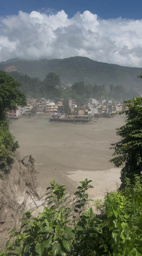 Partially submerged buildings along the riverbank due to a flash flood in Nuwakot district, Nepal, August 26, 2026, in this screen grab obtained from a handout video. Sujan Bagale/Handout via REUTERS
