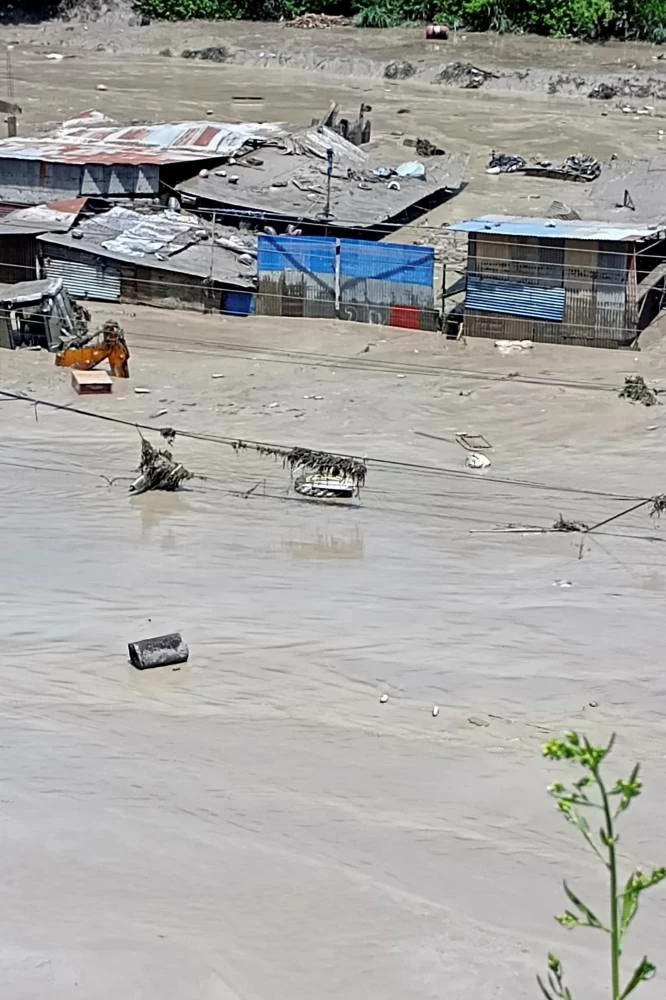 Damaged property and flooded roads following a flash flood in Galchhi in the Dhading district, Nepal, August 26, 2026. Picture taken with a mobile phone. REUTERS/Stringer