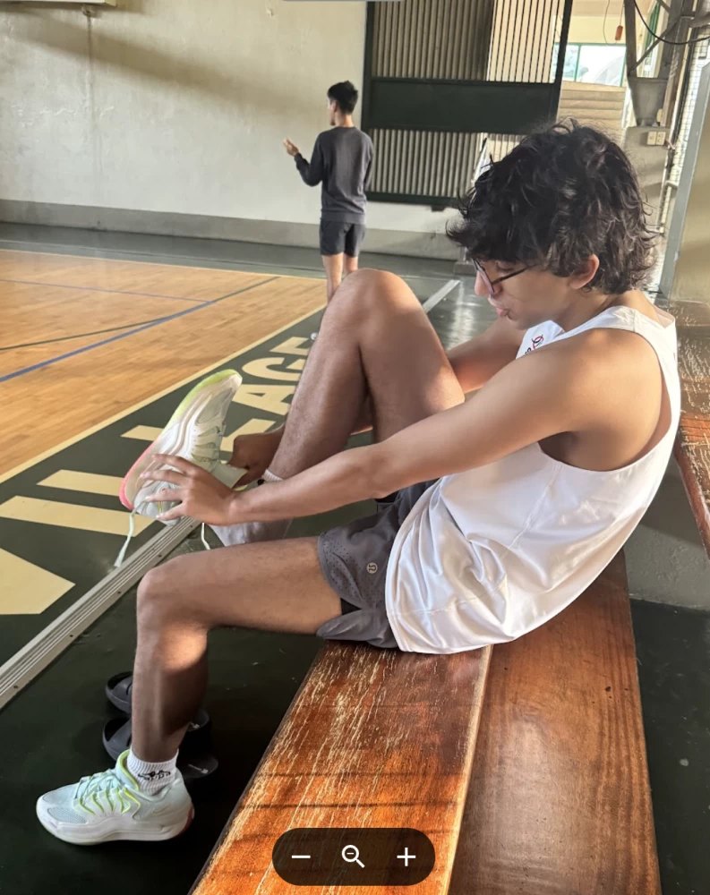 Putting on shoes courtside at the Manila basketball initiative