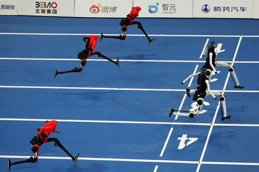 Tiangong Ultra humanoid robots cross the finish line before Honor's Lightning humanoid robots in the 100m large-size group final race, during the second World Humanoid Robot Games at the National Speed Skating Oval in Beijing, China August 26, 2026. REUTERS